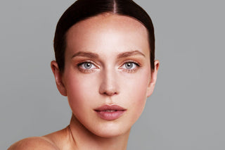 A woman with radiant, even-toned skin, showcasing a natural glow and highlighting ZO Skin Health’s Brightening Collection.